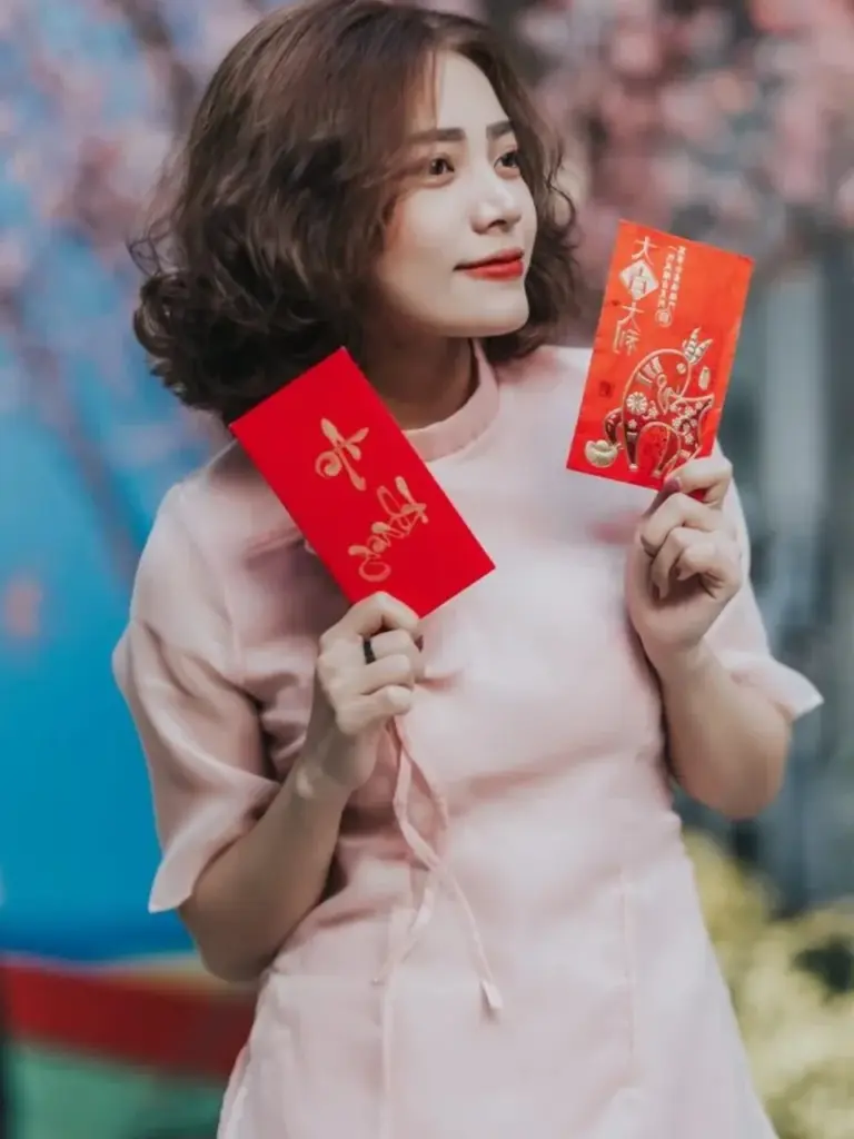 Tạo dáng áo dài đẹp với bao lì xì ngày Tết